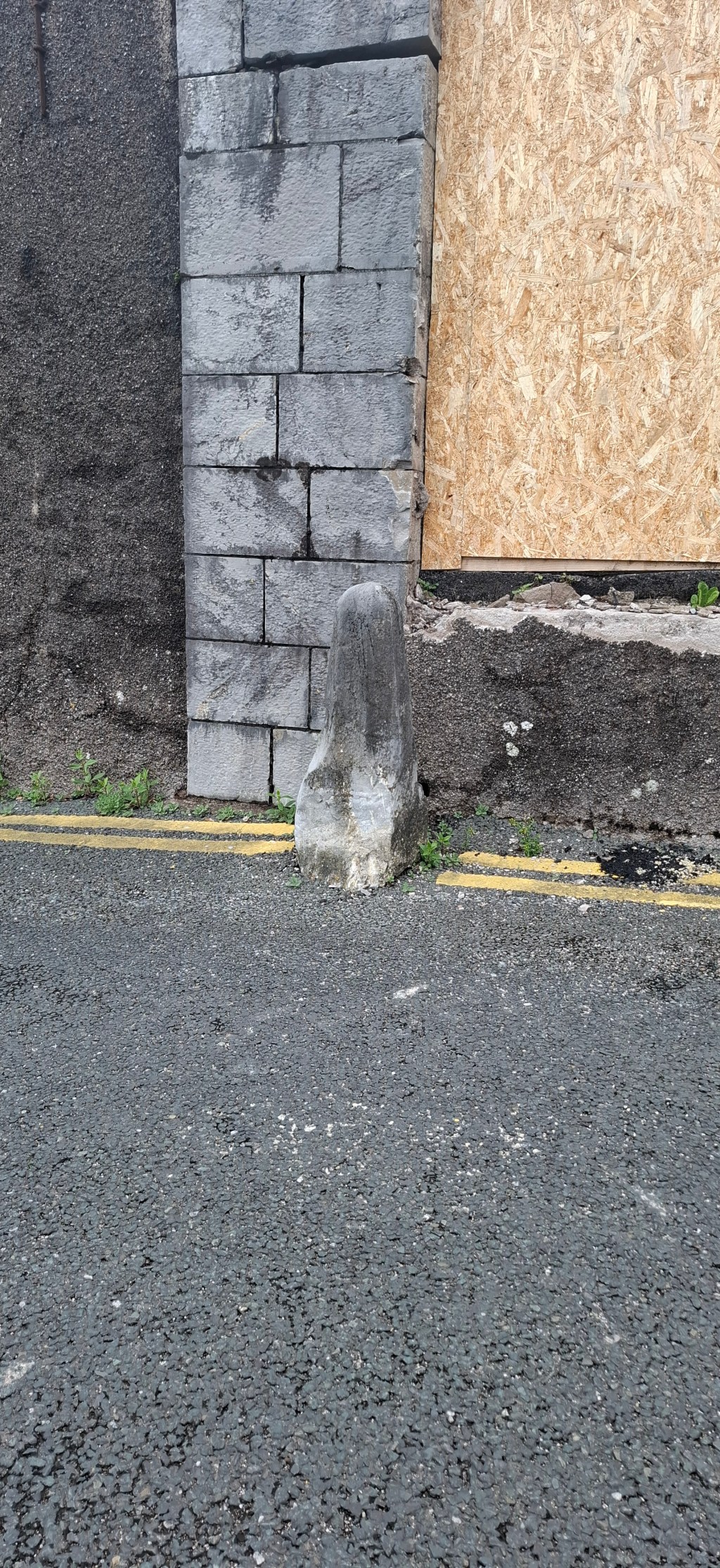 Jostle stone at a boarded-up gap in the wall of Collins Barracks, Cork